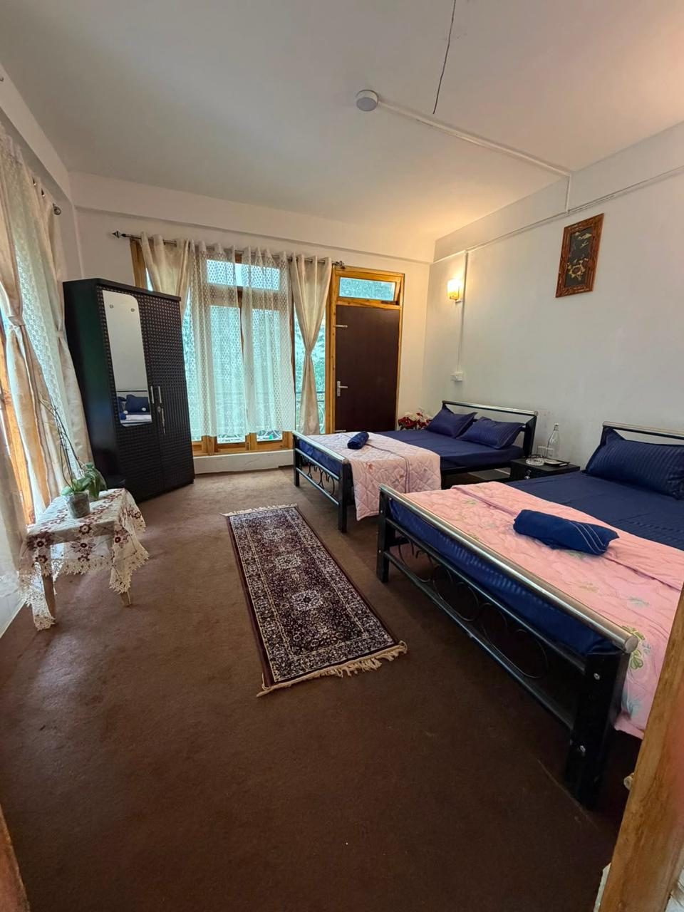 Double bedroom with mountain-facing windows at Kepchaki Stay, best homestay in Lamahatta Darjeeling